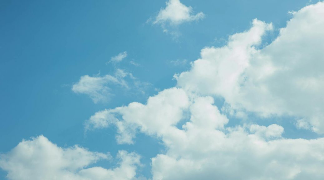 thick clouds in bright blue sky